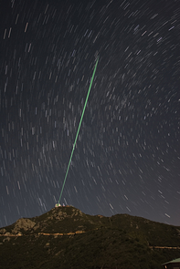 (Click to enlarge) A bundle of laser beams creates five artificial stars in the night sky above Mount Hopkins in Southern Arizona. Laser light reflected by air molecules is analyzed by a computer that drives the actuators on the adaptive mirror. (Image courtesy of Thomas Stalcup) (Click to enlarge) A bundle of laser beams creates five artificial stars in the night sky above Mount Hopkins in Southern Arizona. Laser light reflected by air molecules is analyzed by a computer that drives the actuators on the adaptive mirror. (Image courtesy of Thomas Stalcup)